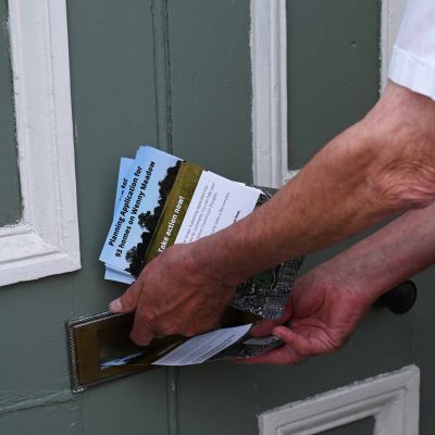 Delivering Save Wenny Road Meadow leaflets - Photograph by Rob Morris